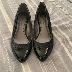 Black snake and patent wedge heel shoes by Adrienne Vittadini.